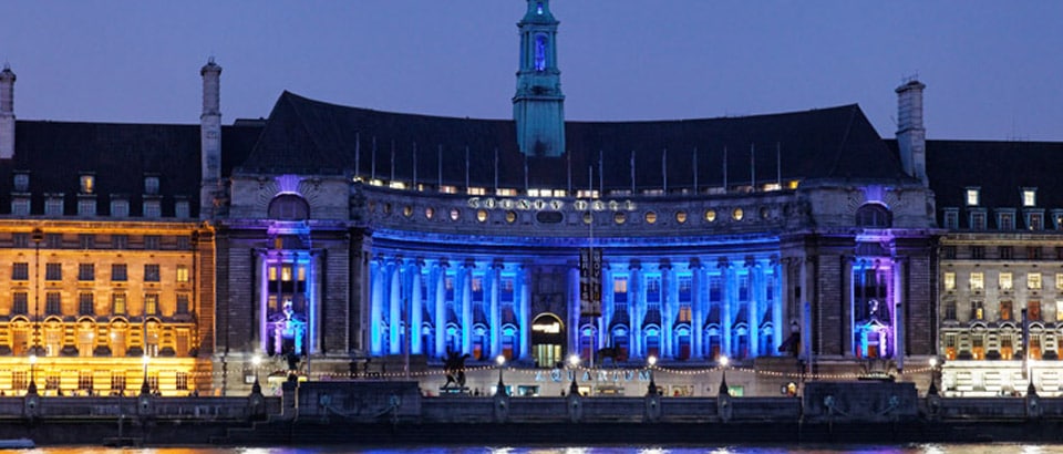 Modern building, brilliantly illuminated with red and blue façade lighting